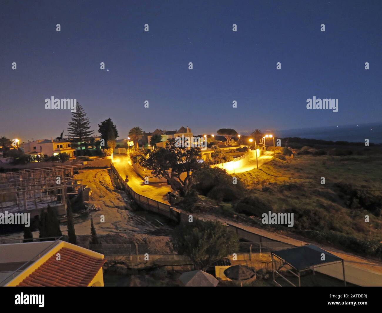 Kleines Dorf mit Abendbeleuchtung an der Algarveküste Stockfoto