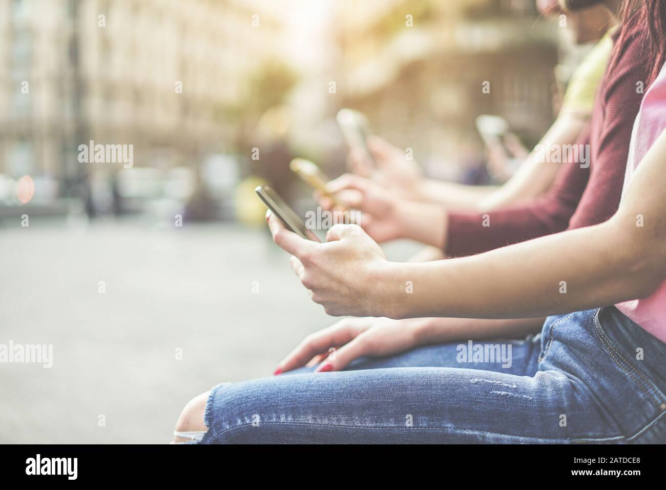 Eine Gruppe von Teenager-Freunden, die Mobiltelefone in der Stadt beobachten - Junge Menschen suchen nach Technologietrends - Entfremdungsmoment für das Problem der neuen Generation Stockfoto