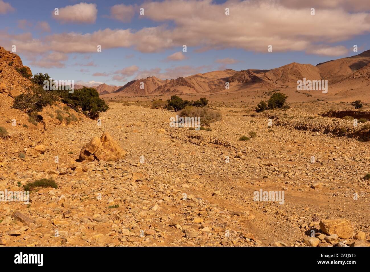 Die Wüste im Süden von marokko, eine Bergkette hinter einem Tal Stockfoto