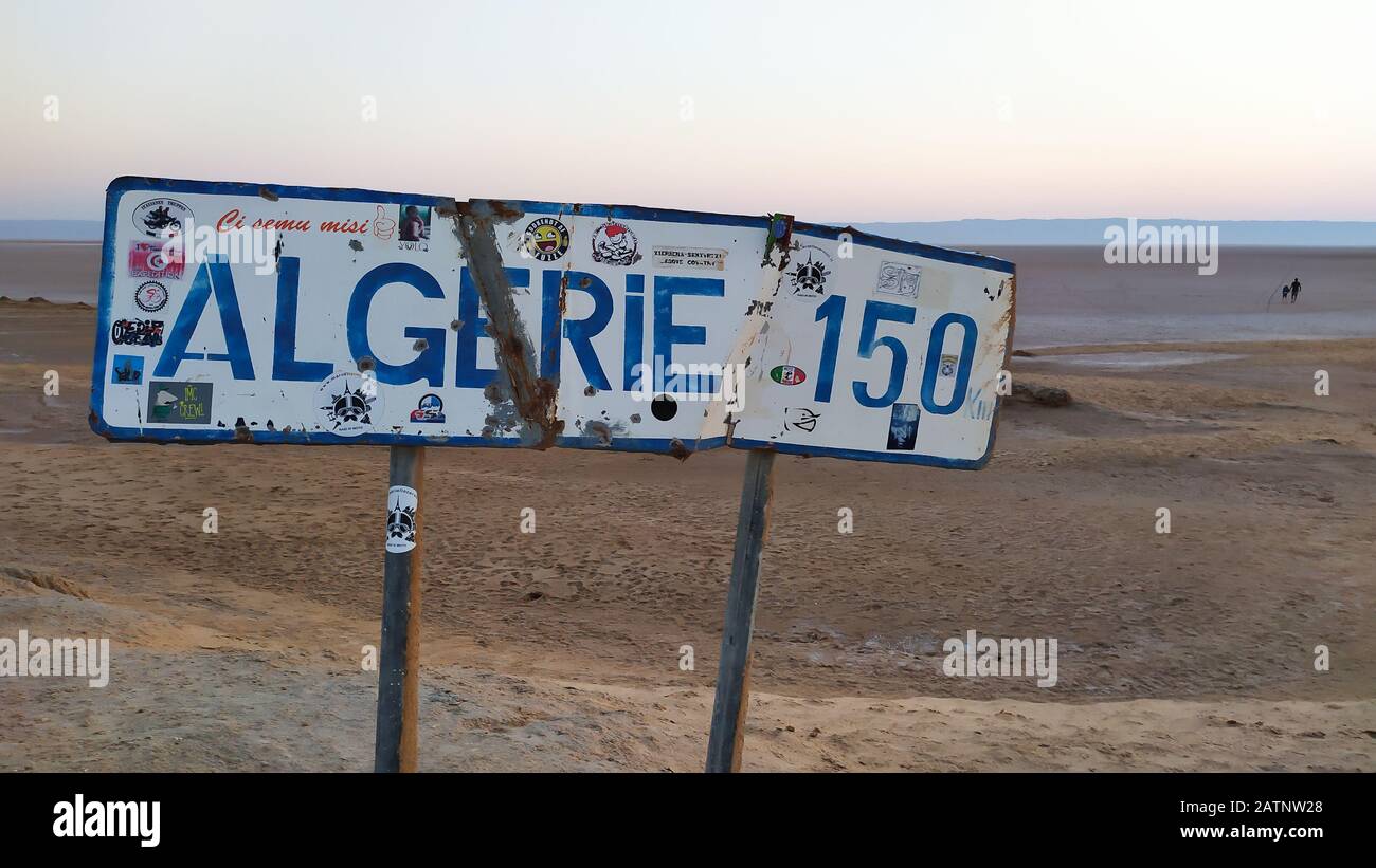 Chott el Jerid Lake, Tunesia - 29. Juni 2019. Schild informiert über die Entfernung zur Grenze zu Algerien am Straßenrand des Autobahnübergangs Chott el Jerid See Stockfoto