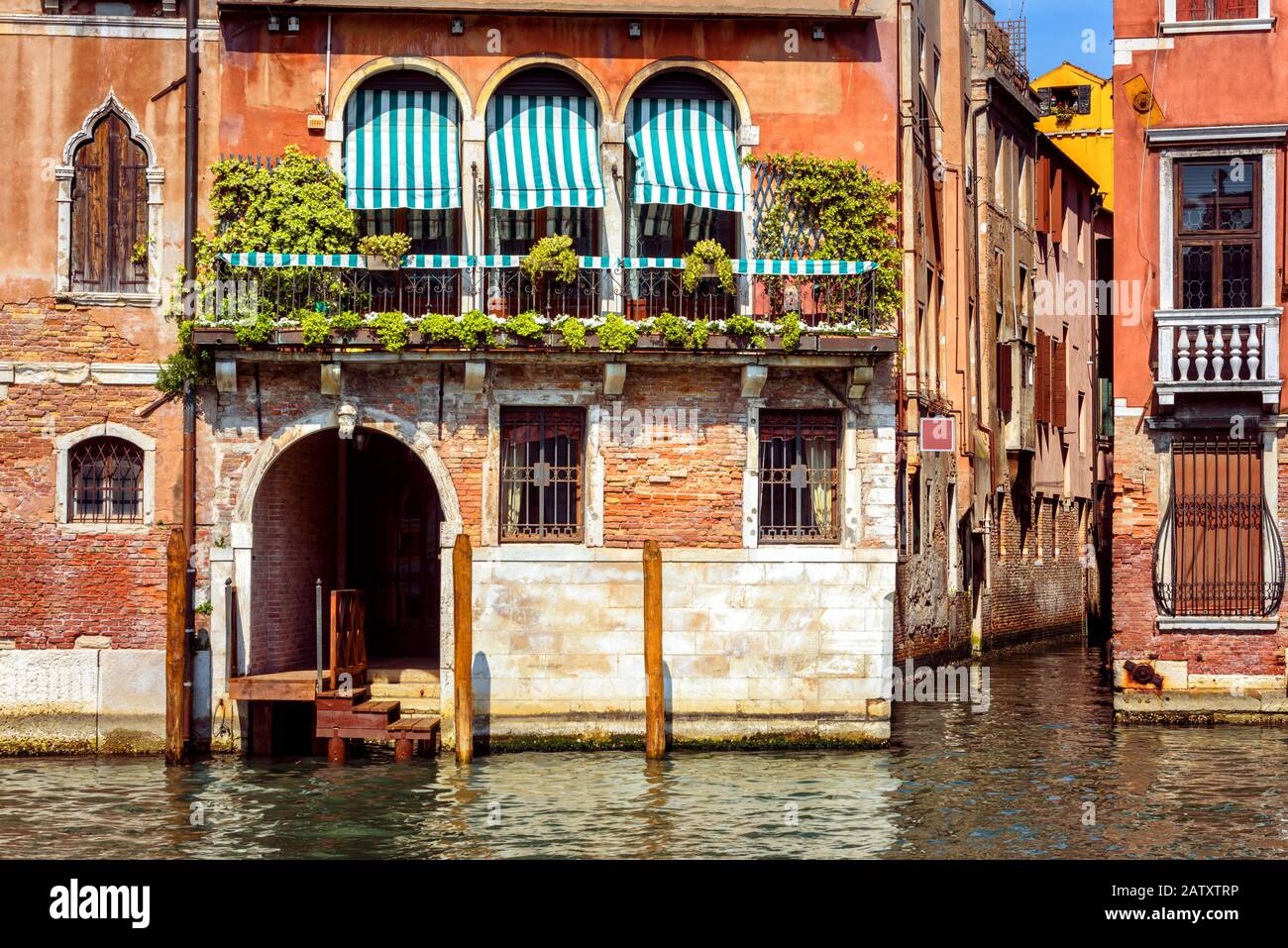 Vintage-Haus, Venedig, Italien. Eingang zum Wohnhaus oder Hotel am Canal Grande, der berühmten Straße von Venedig. Altes Gebäude auf dem Wasser, traditionelle Aussicht Stockfoto