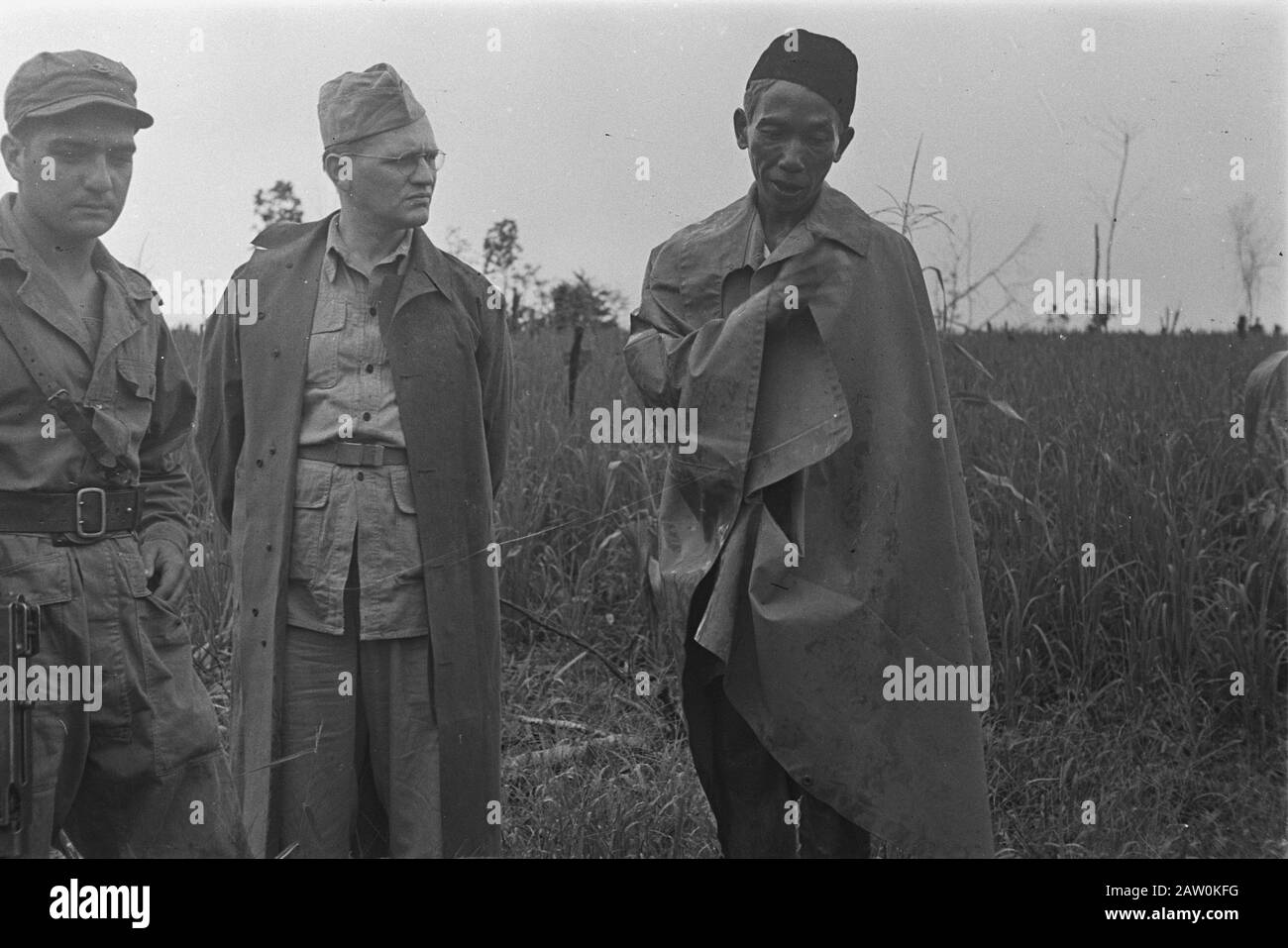 Fotoreportage Palembang holländische Soldaten im Gespräch mit einem Indonesier mit peci und Rain cape Datum: Januar 1947 Ort: Indonesien, Niederländische Ostindien, Palembang, Sumatra: Unbekannt/DLC Urheberrechtsinhaber: National Archives Material Typ: Negativ (schwarz/weiß) Archivnummer: Siehe Zugang 2.24.04.03 Stockfoto
