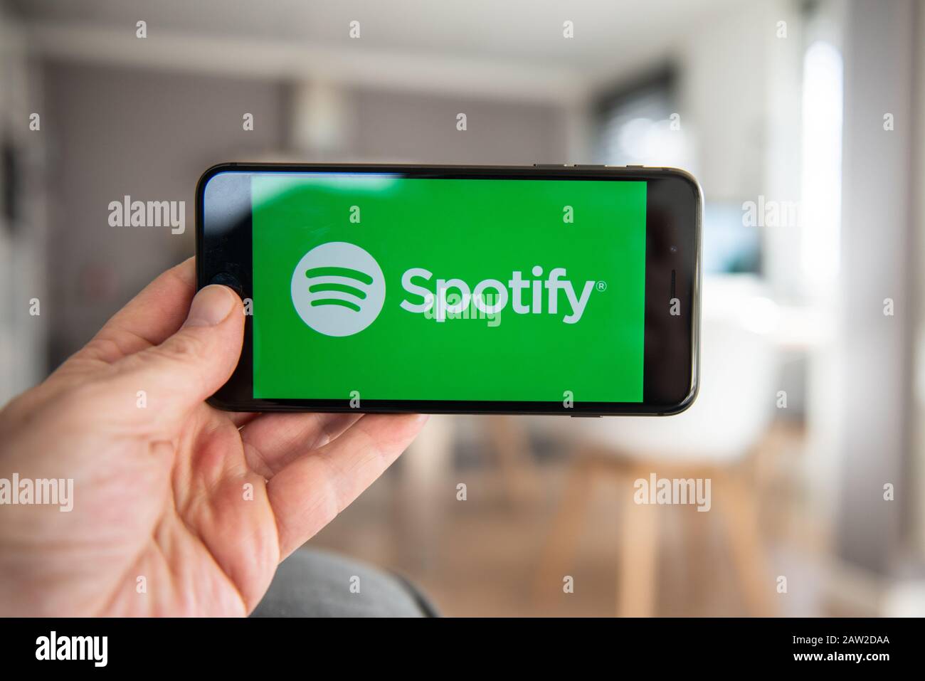 Amsterdam, Niederlande, 02/06/2020, Mann, der sein Telefon hält, Spotify Startbildschirm auf Smartphone, mobiler Bildschirm. Abonnement für Musik-Content-Streaming Stockfoto