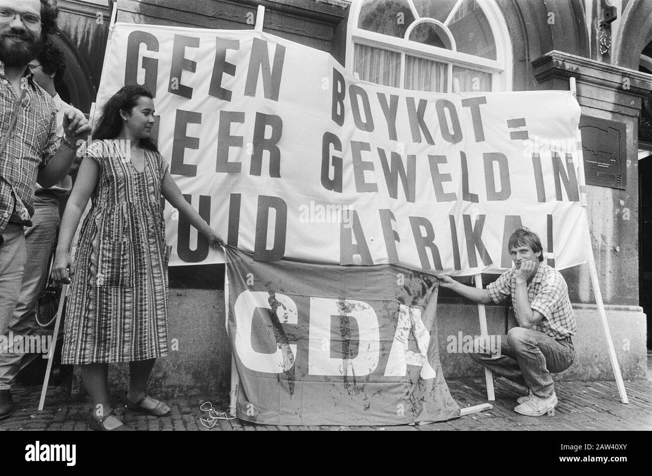Debatte über den Hinweis der Regierung auf einen Boykott Südafrikas in der Beschreibung des Hauses: Protest am Eingang mit einer blutigen CDA-Flagge und einem Banner ohne Boykot = mehr Gewalt Südafrika Datum: 21. Juni 1983 Ort: Den Haag, South Holland Schlüsselwörter: Apartheid, Demonstrationen, Boykott, Banner Institution Name: Unterhaus Stockfoto