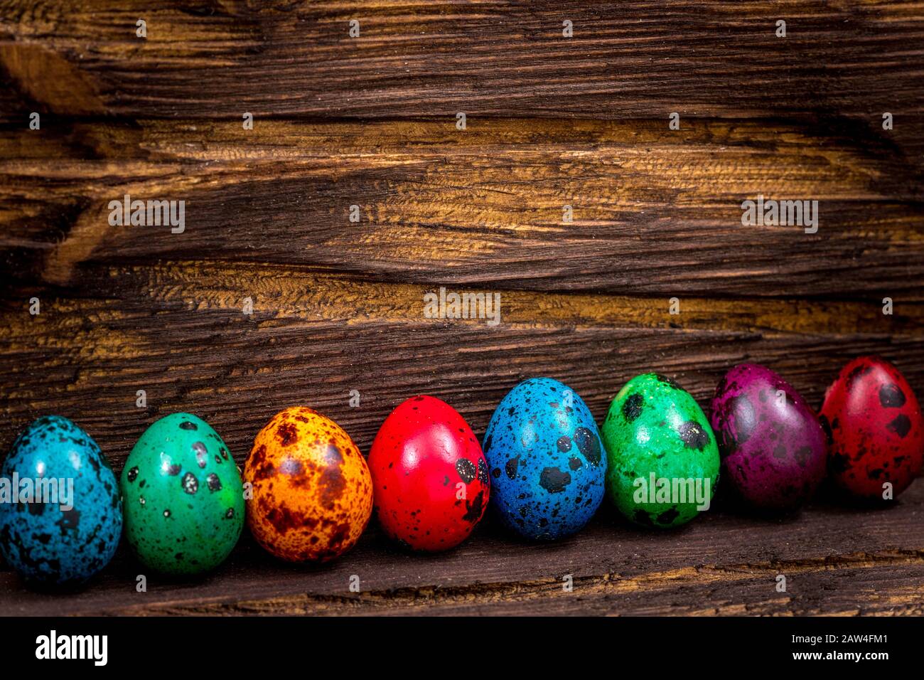 Bemalte Eier verschiedener Farben auf einem Holztisch, Osterdekoration, Platz für Text Stockfoto