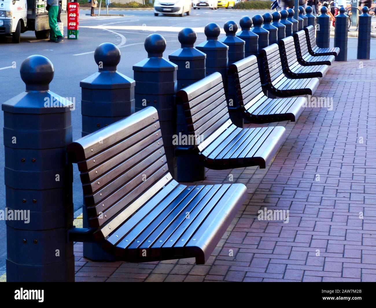 Budapester Straßenbild und Perspektive: Dekorative Stahlbollards, Holzparkbänke, gepflasterter Bürgersteig aus Backstein, Straßenszene an der Großen Synagoge. Stockfoto