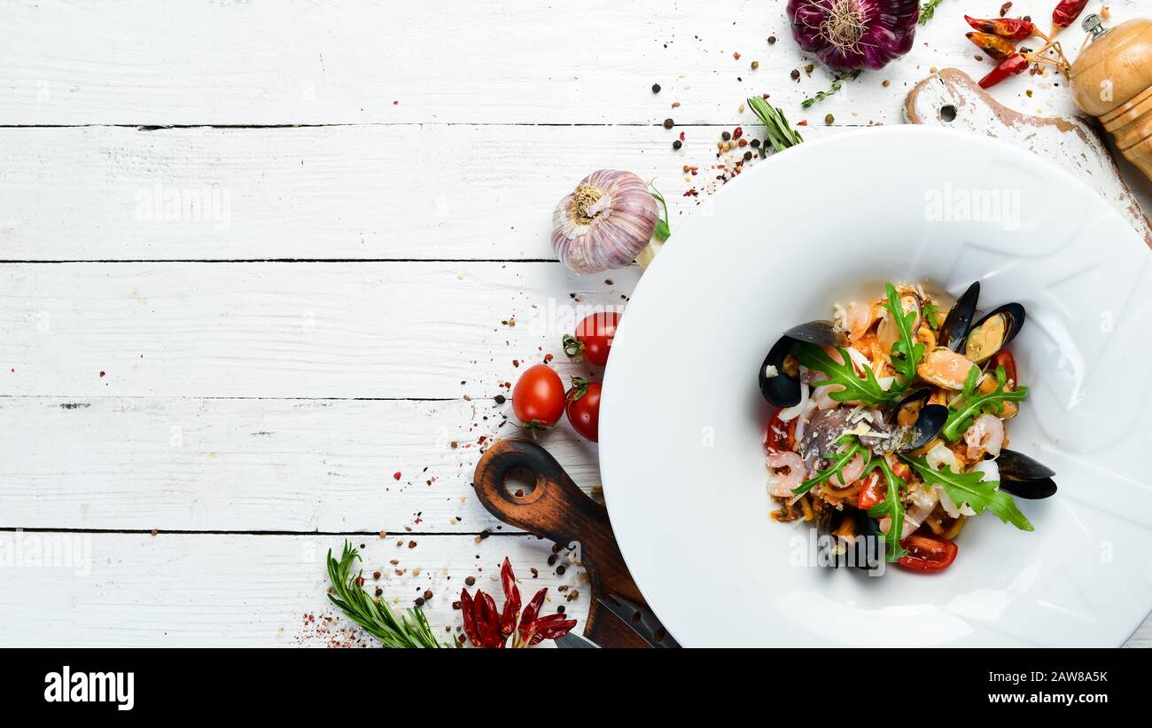 Traditionelle Pasta aus Fisch und Meeresfrüchten auf einem Teller. Muscheln, Garnelen, Tintenfisch. Draufsicht. Freier Speicherplatz. Stockfoto