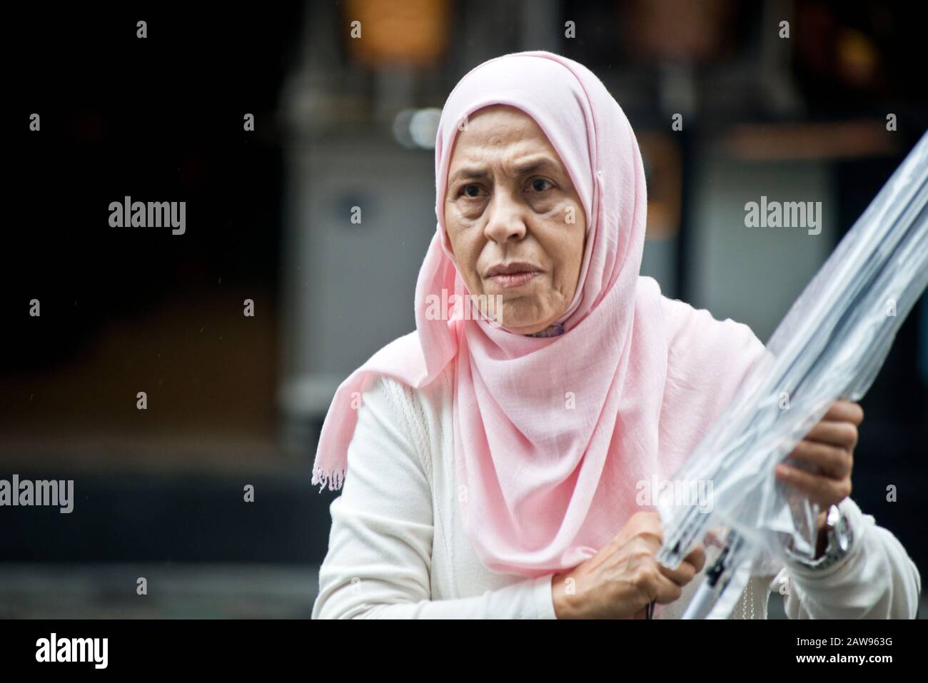 Istanbul: Eine muslimische Frau mit Regenschirm in der Istiklal-Allee. Türkei Stockfoto