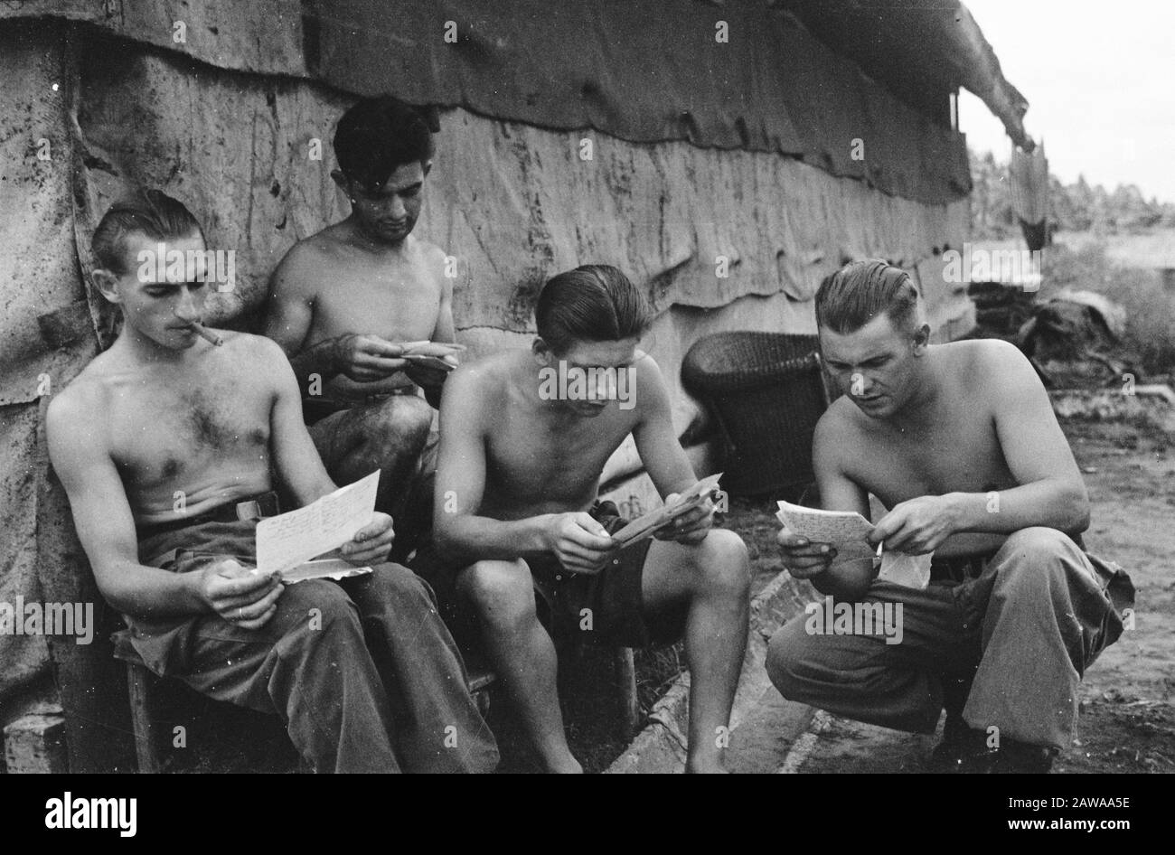 Regiment Hunters Padang Männer lesen Briefe Anmerkung nach Hause: Tut Ihre große warme Sympathie der niederländischen Heimat all Ihre Jungs Datum: Februar 1947 Ort: Indonesien, Niederländische Ostindien, Padang, Sumatra Stockfoto