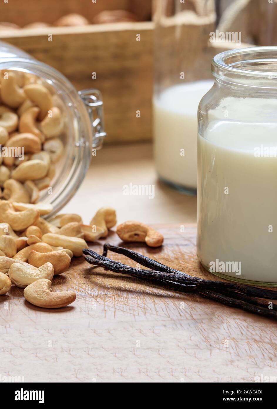 Cashews Milch, keine Milchmilchsubstitution auf einem Holztisch. Cashews Nüsse und Glas mit Milch, laktosefreie Milch für Veganer Stockfoto