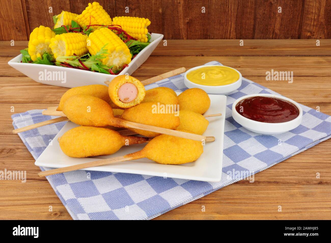 Mini-Party-Corndogs auf Holzstäbchen mit Senf- und Tomatensauce Dips Stockfoto