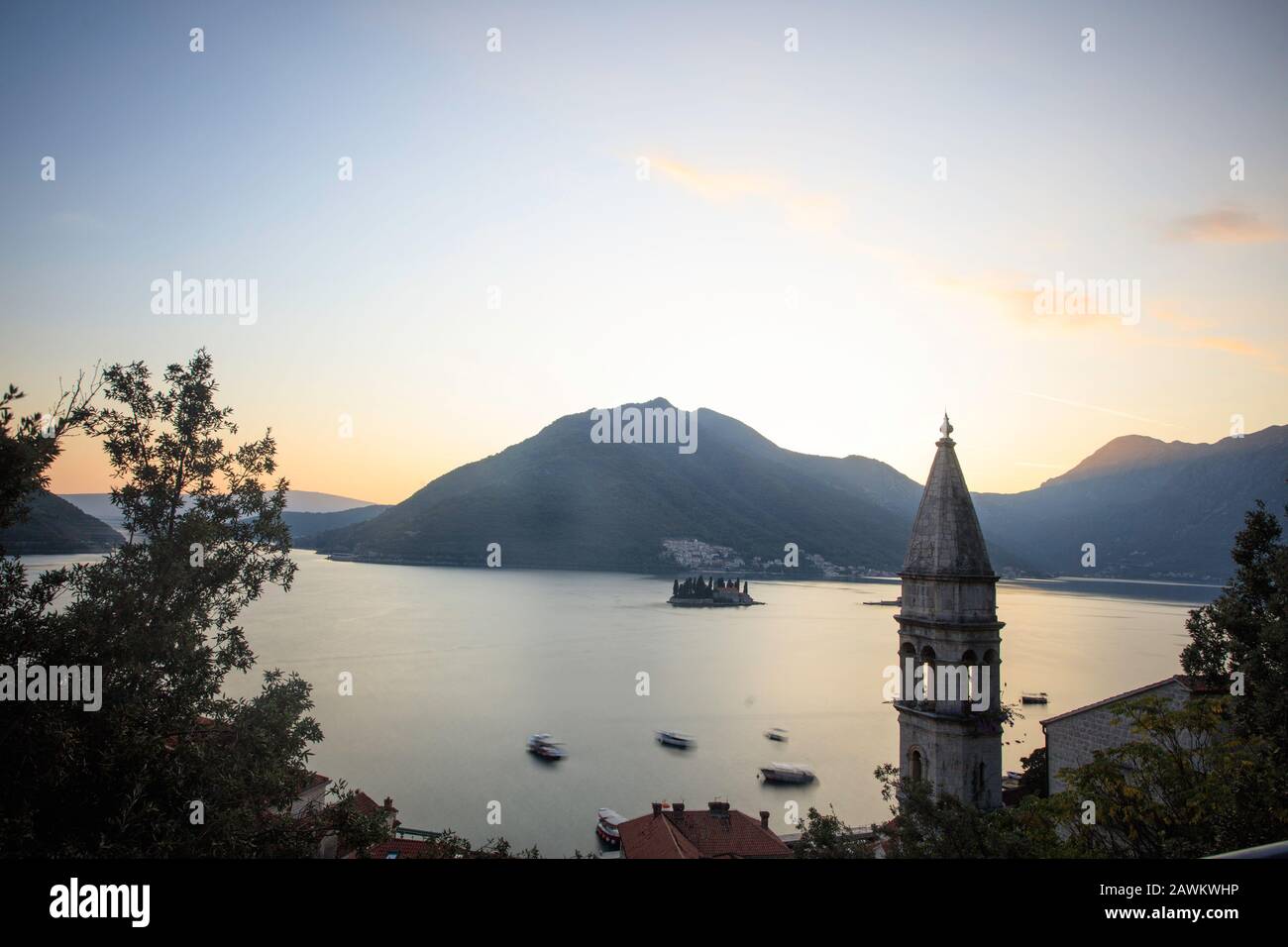 Sonnenuntergang über Perast mit der Kirche Sankt Nikolaus auf der rechten Seite und den Inseln, Sveti Dorde und Our Lady of the Rocks direkt dahinter. Kotor Bay. Montenegro Stockfoto