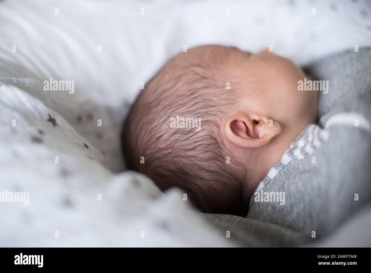 Nahaufnahme des unschuldigen neugeborenen Jungen, der schläft Stockfoto