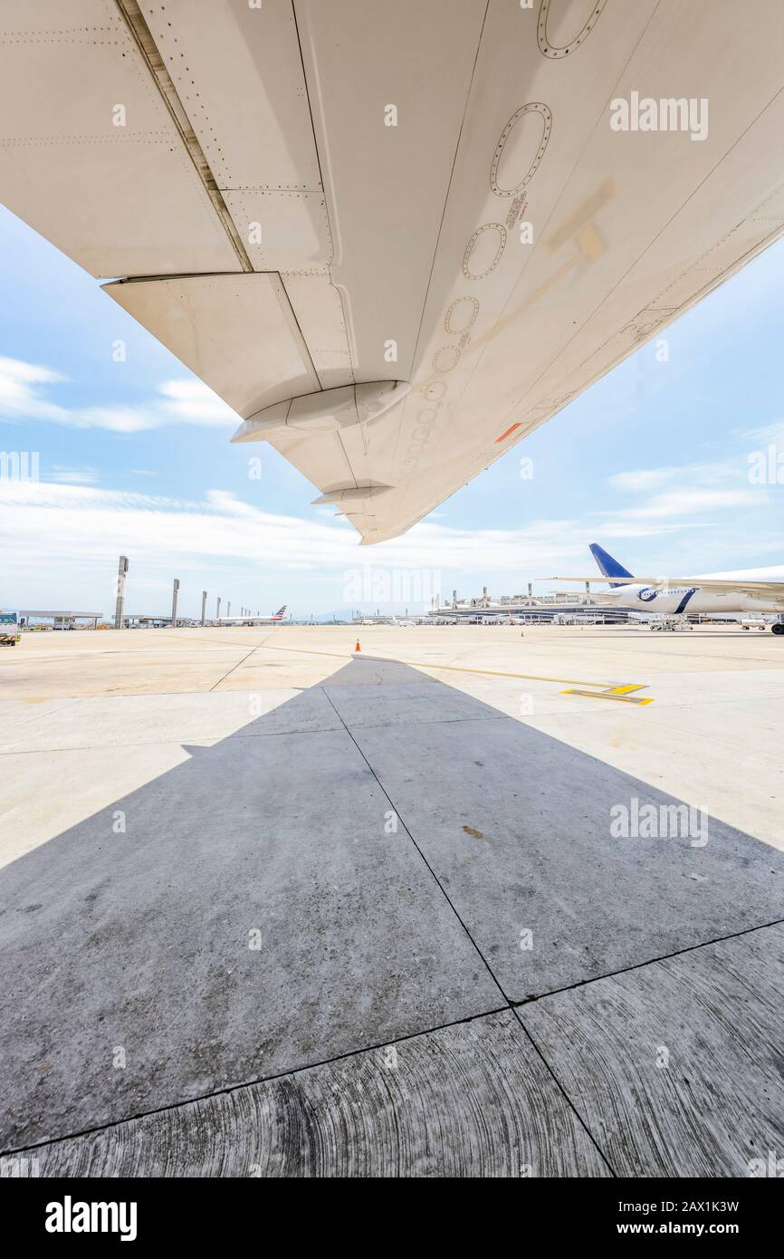 Unter dem Flügel des Jet Airliners mit Asphalt Stockfoto