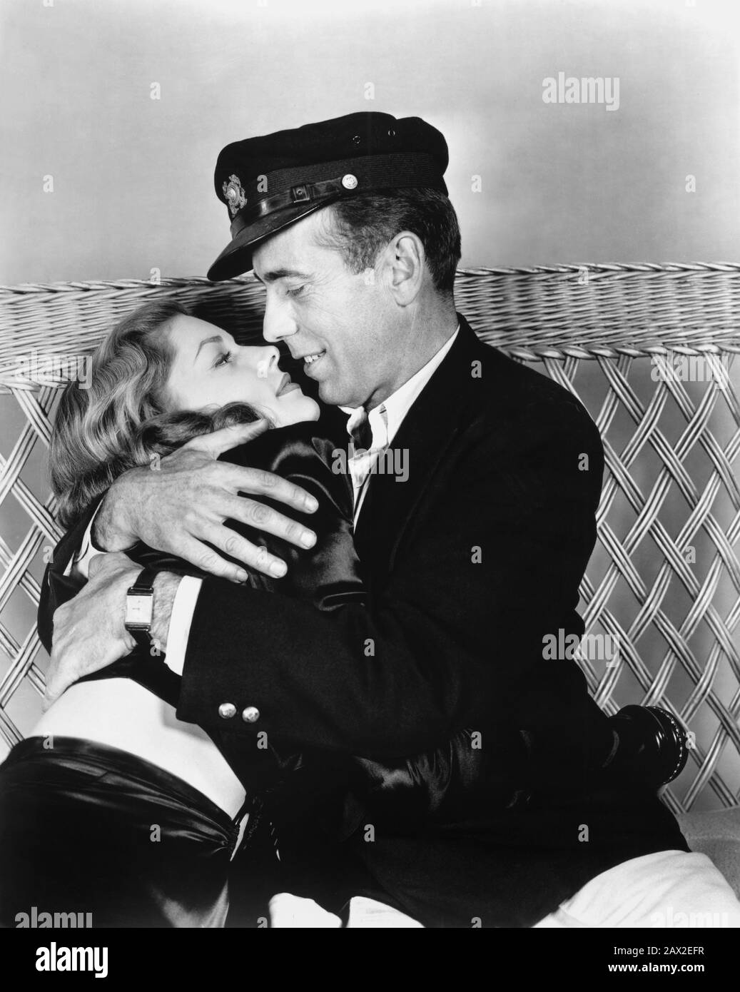 1944 , USA : Der Filmschauspieler HUMPHREY BOGART mit Frau LAUREN BACALL ( geborene Betty Weinstein Perske , New York 1924 ) hat UND HAT NICHT ( Acque del Sud ) von Howard Hawks. Aus einem Roman von Ernest Hemingway - FILM - KINO - FILM - FILM - Film - Liebhaber - innamorati - Amanti - Profilo - Profil - Kuss - Bacio - Bionda - blondes Haar - Blondie - Capelli biondi - dunkle Dame - Darklady - Darklady - Dark-Lady - - - - - -- - Archivio GBB Stockfoto