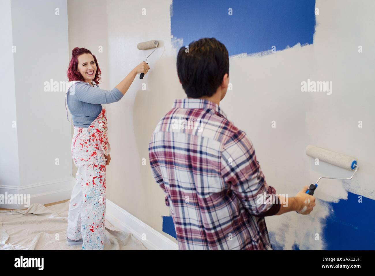 Glückliches Paar, das Wand malt Stockfoto