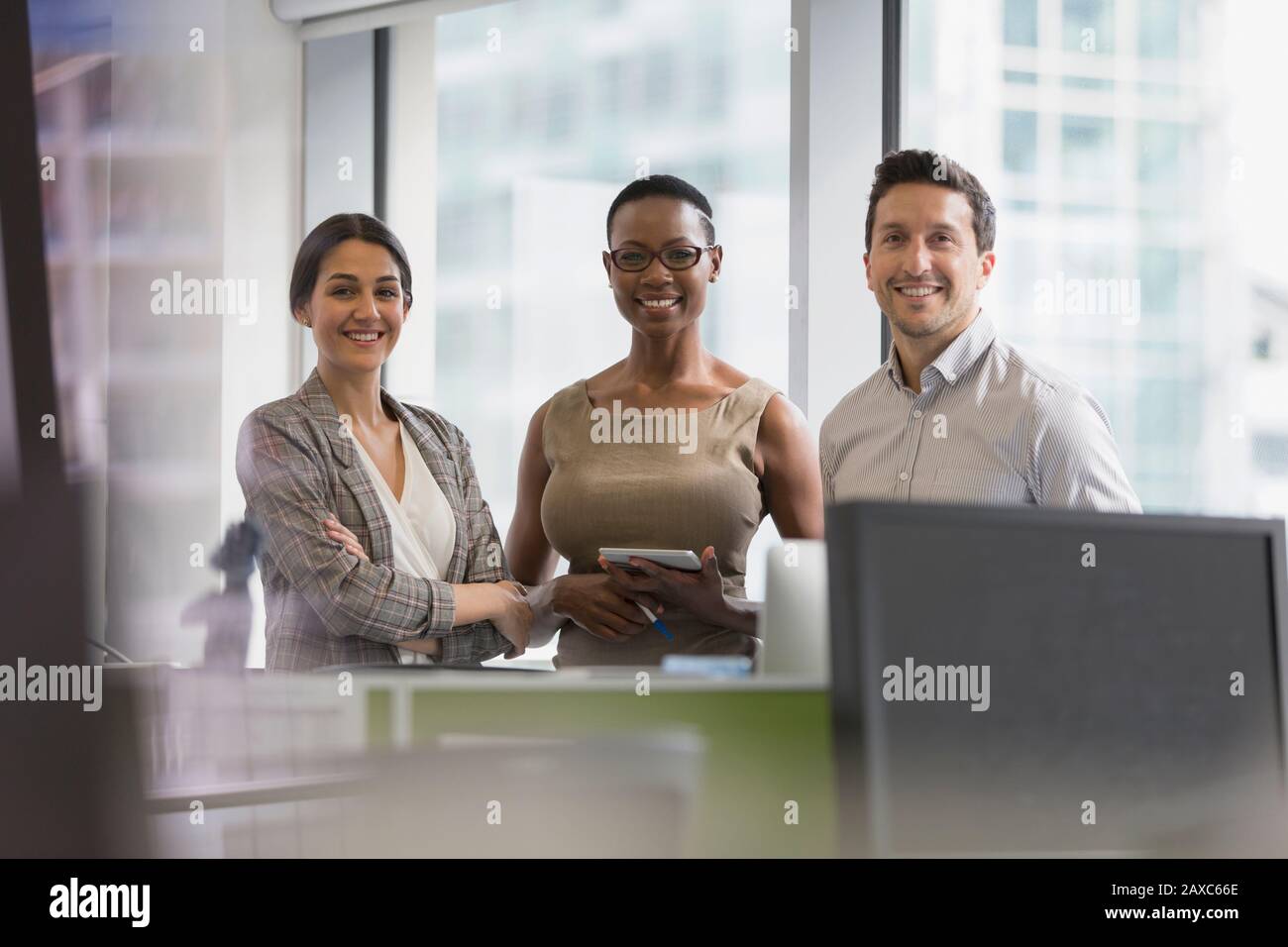 Portrait selbstbewusste, lächelnde Geschäftsleute im Büro Stockfoto