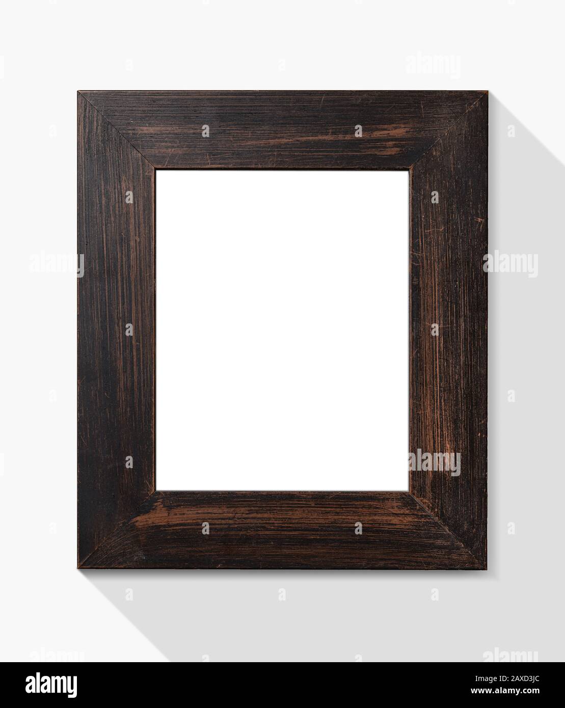 Leerer Bilderrahmen aus Holz an der weißen Wand Stockfoto