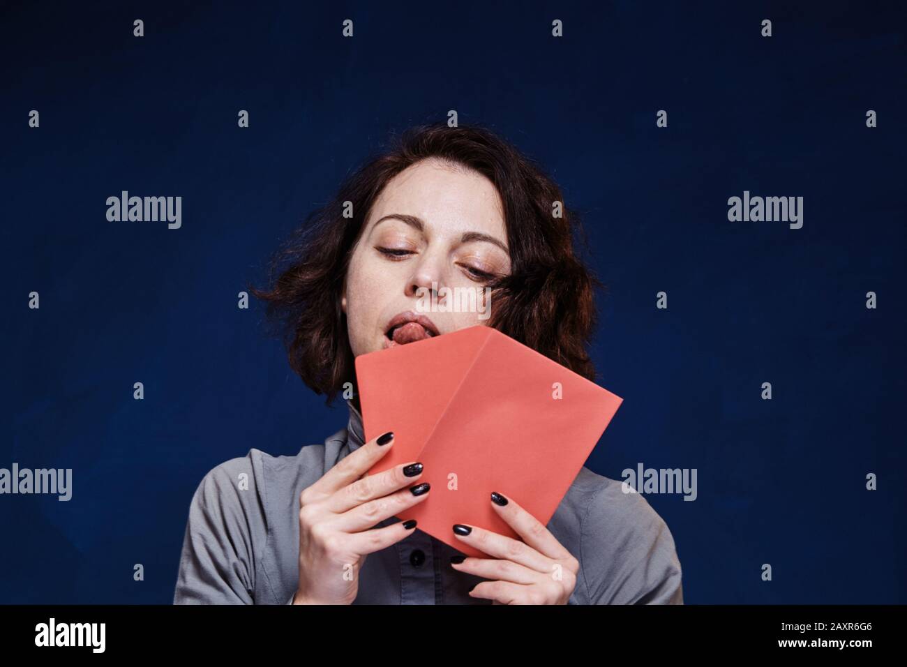 Eine Frau wird diesen rosafarbenen Brief schicken Stockfoto