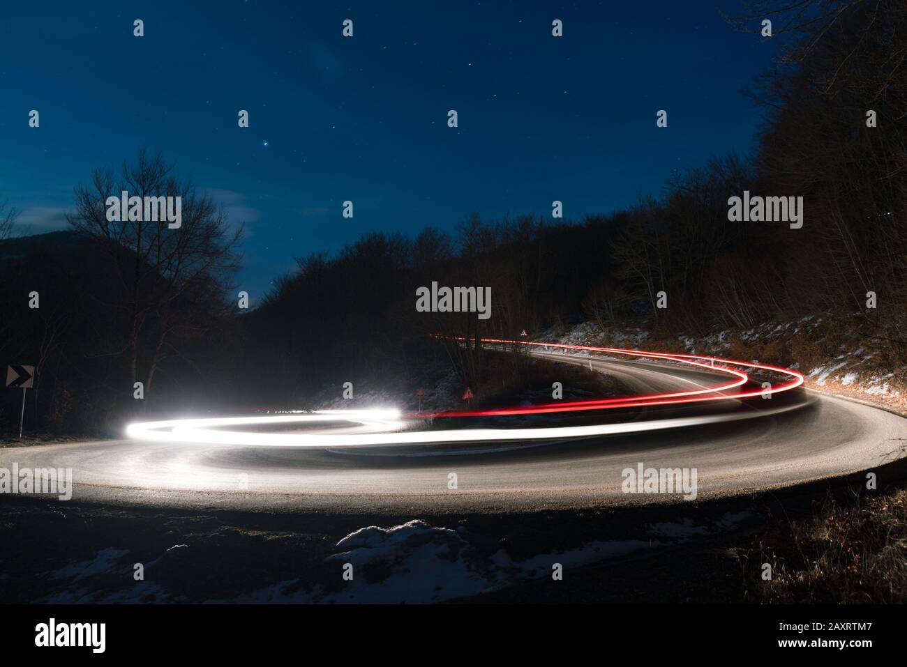 Lichter der Autos auf der Kurve der Straße an Nacht Stockfoto