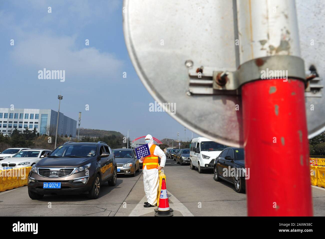 Qingdao, Qingdao, China. Februar 2020. Am 13. Februar 2020 zeigten Freiwillige Schilder an der Ausfahrt der östlichen Schnellstraße in Qingdao, um die Straßenverwaltung bei der Umlenkung von Fahrzeugen in die Stadt zu unterstützen. Kredit: SIPA Asia/ZUMA Wire/Alamy Live News Stockfoto