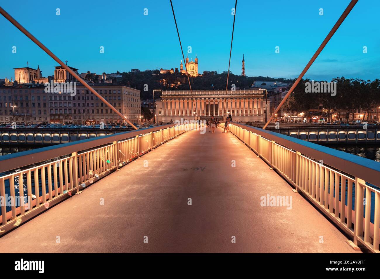 23. Juli 2019, Lyon, Frankreich: Stadtbild der Nacht von Lyon mit beleuchtetem Courthouse und roter Fußgängerbrücke über den Fluss Saone. Panorama-Blau-Stundenlandschaft Stockfoto