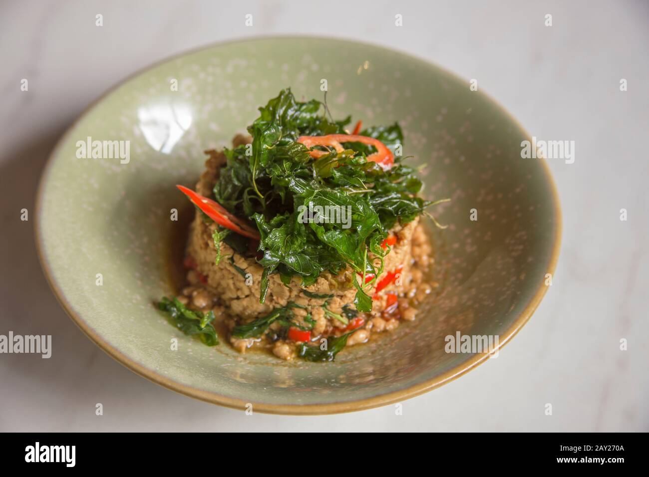 Thailändische Gerichte zeichnen sich durch leicht zubereitete Gerichte mit starken aromatischen Komponenten und einer würzigen Note aus. Das ist Hackfleisch-Schweinefleisch, gebraten mit heiligem Basilikum Stockfoto