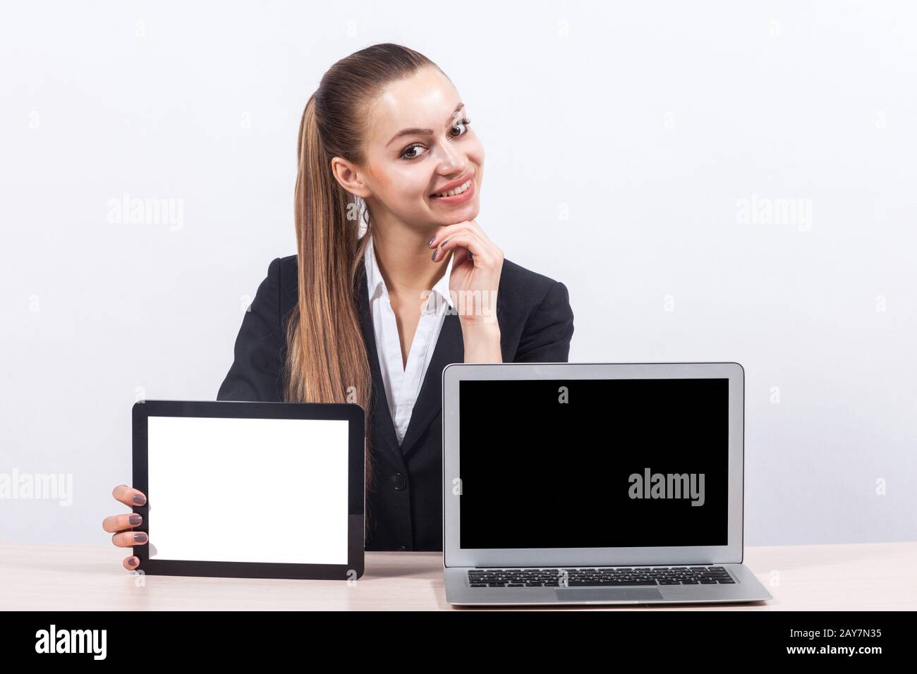 Bild einer schönen Geschäftsfrau, die PC und Tablet-Computer zeigt Stockfoto