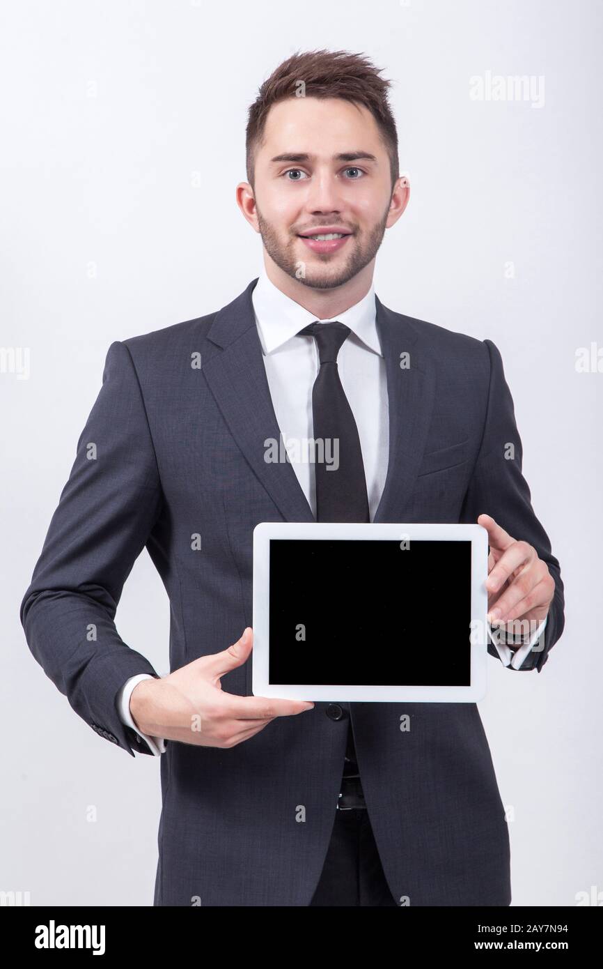 Lächelnder erfolgreicher junger Student auf weißem Hintergrund in einem Clas Stockfoto