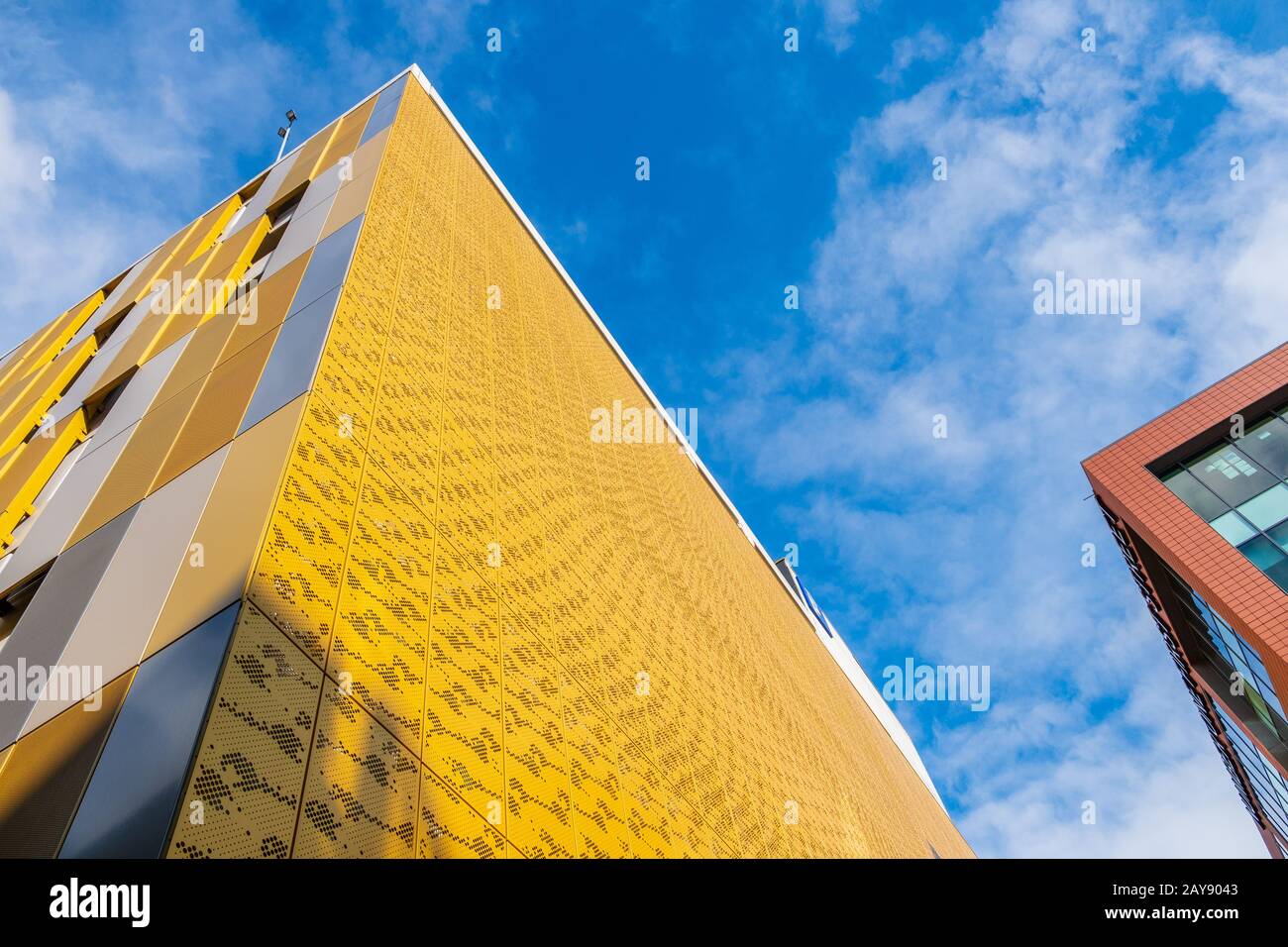 Kontrastierende Farben und Formen an Gebäudefassaden gegen den Himmel in Manchester, Großbritannien Stockfoto