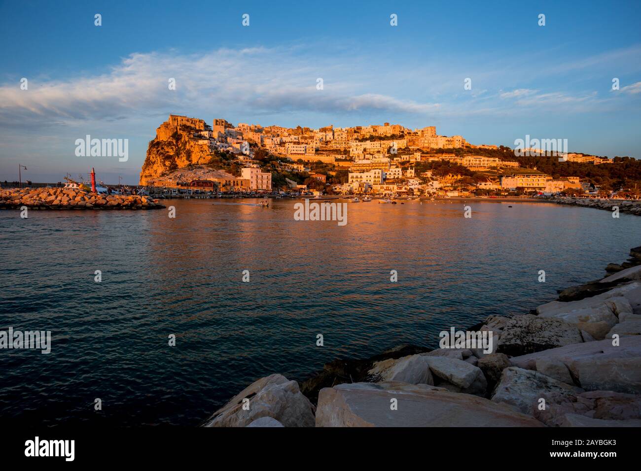 Sonnenuntergang beleuchtete Stadt über dem Meer Stockfoto
