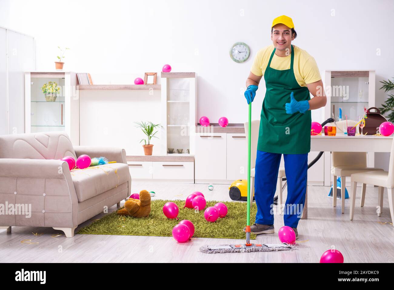 Junge männliche Auftragnehmer tun Hausarbeit nach Partei Stockfoto