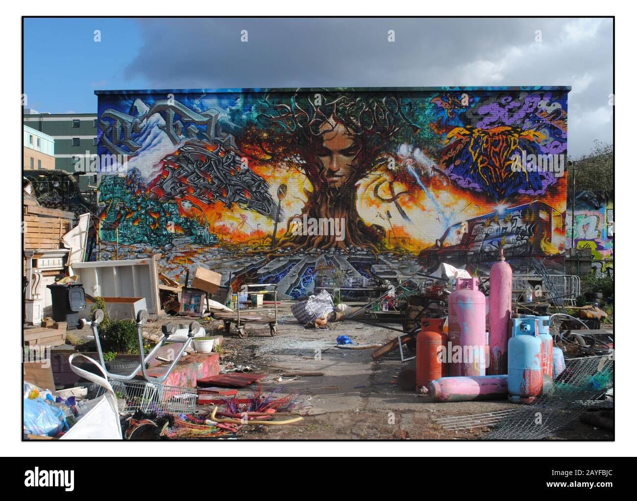 IM GESCHLOSSENEN NOMADISCHEN GEMEINSCHAFTSGARTEN, SHOREDITCH, MIT EINEM GROSSEN WANDGEMÄLDE AN DER EX-VIADUKTWAND. Stockfoto