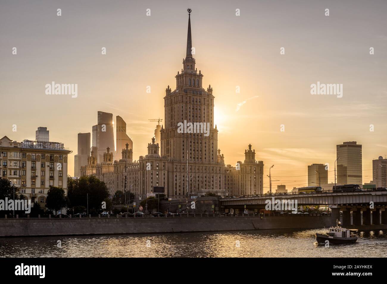 Moskau Alter Wolkenkratzer des Radisson Royal Hotel (Ukraine) bei Sonnenuntergang, Russland. Es ist ein Wahrzeichen Moskaus. Sonniger Blick auf den Fluss Moskva mit urbanem Tall Stockfoto
