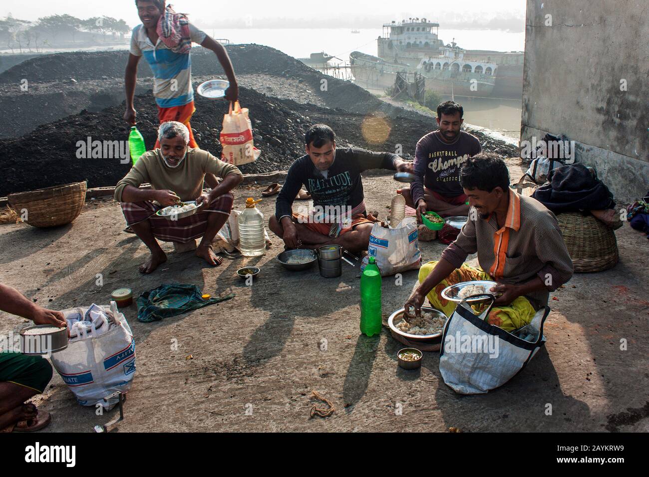 Der Arbeiter trägt einen Korb Kohle, der im Brennofen eines Maurers verwendet werden soll.Khulna, Bangladesch. Stockfoto