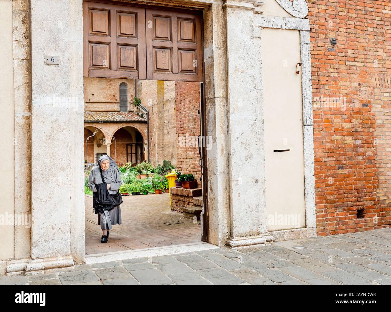 17. OKTOBER 2018, SIENA, ITALIEN: Alte Frau Nonne am Eingang des Klosters in Siena Stockfoto