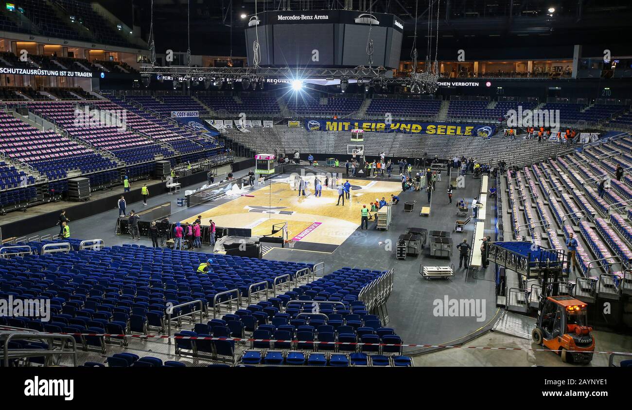 Berlin, Deutschland. Februar 2020. Am ersten Doppeltag wird die Mercedes  Benz Arena von der Eishockeyeinrichtung auf die Basketballeinrichtung  umgestellt. Während der Einrichtung des Basketballparketts richten die  Mitarbeiter den Basketballkorb ein. Es ...