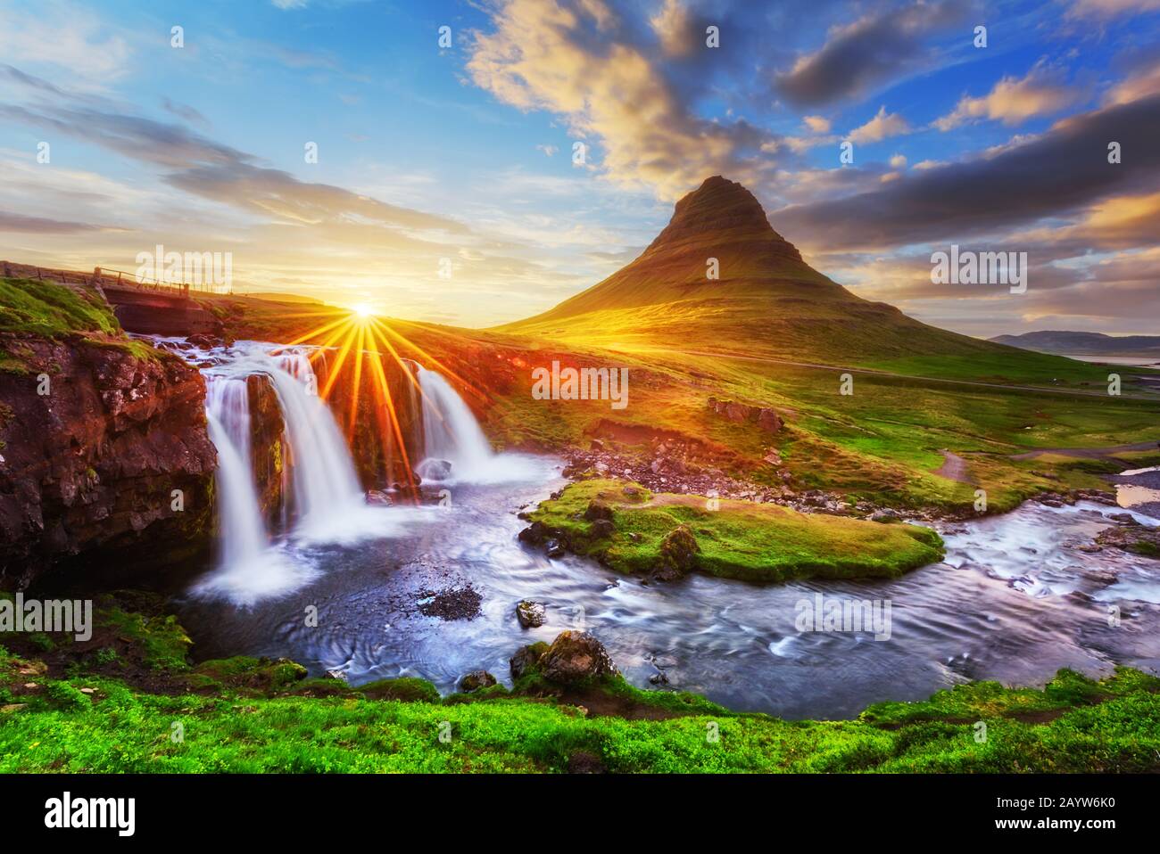 Morgenlandschaft mit aufsteigender Sonne am Wasserfall Kirkjufellsfoss und am Berg Kirkjufell, Island, Europa. Stockfoto