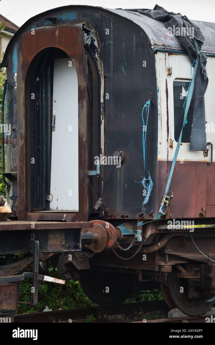 Ein alter Reisewagen, der auf die Wiederherstellung auf einem Abstellplatz am Bahnhof Minehead der West Somerset Railway wartet. Stockfoto