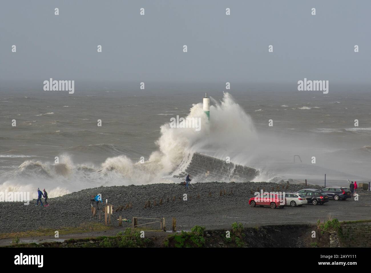 Die Sturmwinde, die über 60mph Uhr stürmen, und die morgendliche Flut verbinden sich und bringen riesige Wellen über die Irische See, um Aberystwyth zu schlagen. Stockfoto