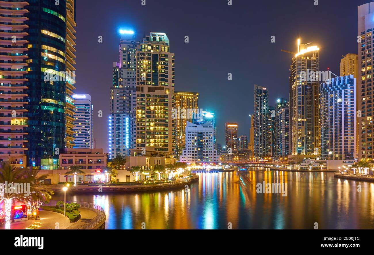 Moderne Wolkenkratzer von Dubai Marina in der Nacht und ihre Reflexionen im Wasser, Vereinigte Arabische Emirate Stockfoto