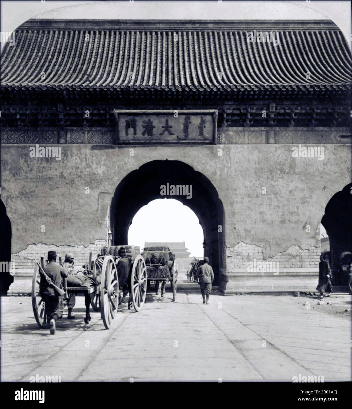 China: Pferdewagen, die durch die Da Qing Men oder das „große Qing-Tor“, auch Kaiserliches Tor genannt, 1901 in die Kaiserstadt von Peking gelangen. Die Kaiserstadt (Chinesisch: Běijīng Huángchéng; Manchu: Dorgi hoton, wörtlich „die Innere Stadt“) ist ein Teil der Stadt Peking in den Ming- und Qing-Dynastien, mit der Verbotenen Stadt im Zentrum. Es bezieht sich auf die Sammlung von Gärten, Schreinen und anderen Servicebereichen zwischen der Verbotenen Stadt und der Inneren Stadt des alten Peking. Die Kaiserstadt war von einer Mauer umgeben und durch sechs Tore zugänglich. Stockfoto