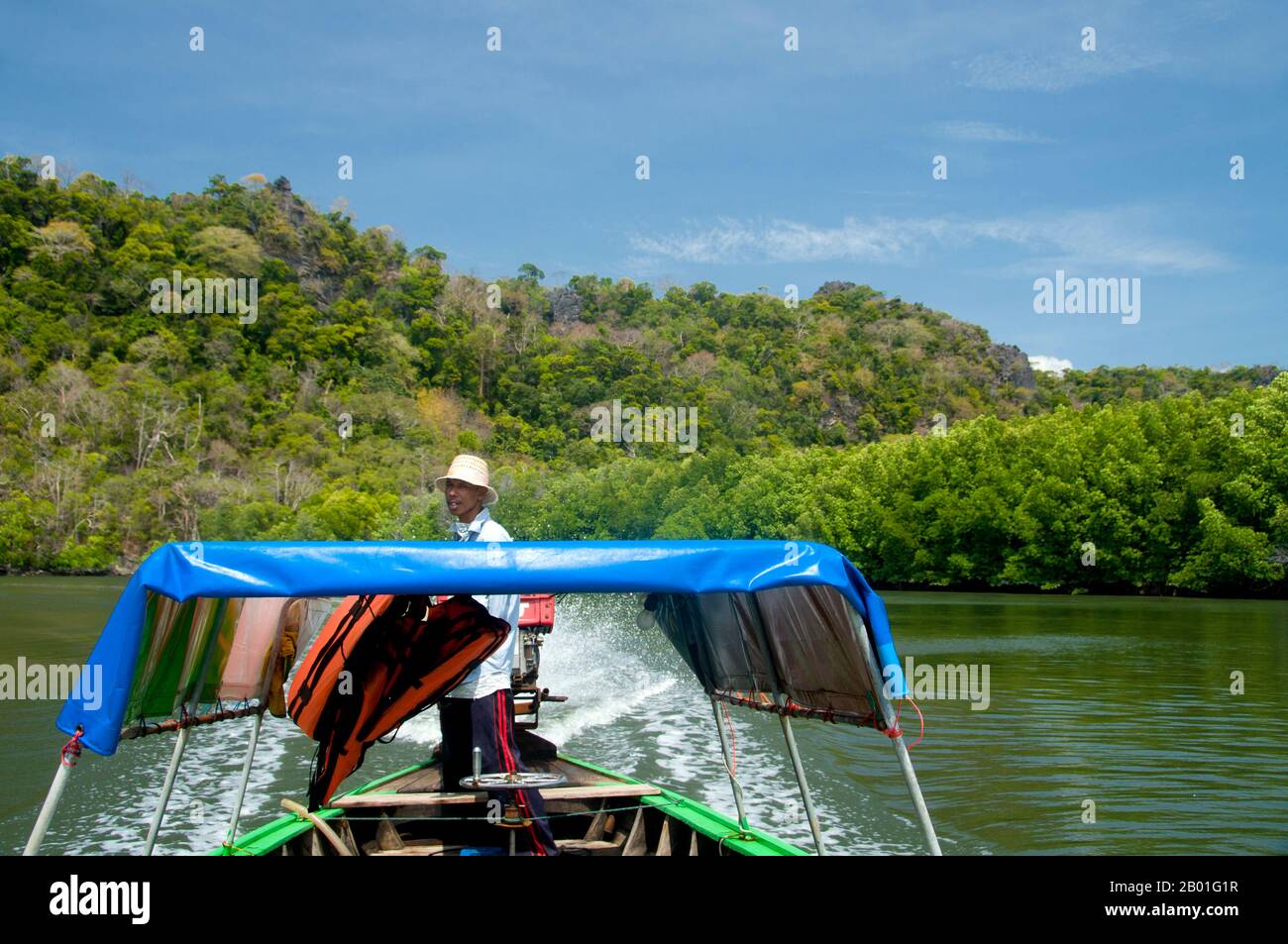 Thailand: Bootsmann in der Nähe der Klippen von to-BU (Toe-Boo), Ko Tarutao, Ko Tarutao Marine Nationalpark. Der Marine-Nationalpark Ko Tarutao besteht aus 51 Inseln in zwei Hauptgruppen, die über die Andamanensee im südlichsten Thailand verstreut sind. Nur sieben der Inseln haben jede Größe, einschließlich Ko Tarutao im Osten und Ko Adang-Ko Rawi im Westen. Nur 5 Meilen (8 km) südlich liegt die Meeresgrenze mit Malaysias gefeiertem Langkawi-Archipel. Tarutao ist weltberühmt für seine unberührten Tauchplätze, die reiche Unterwasserwelt und die außergewöhnliche natürliche Schönheit. Stockfoto