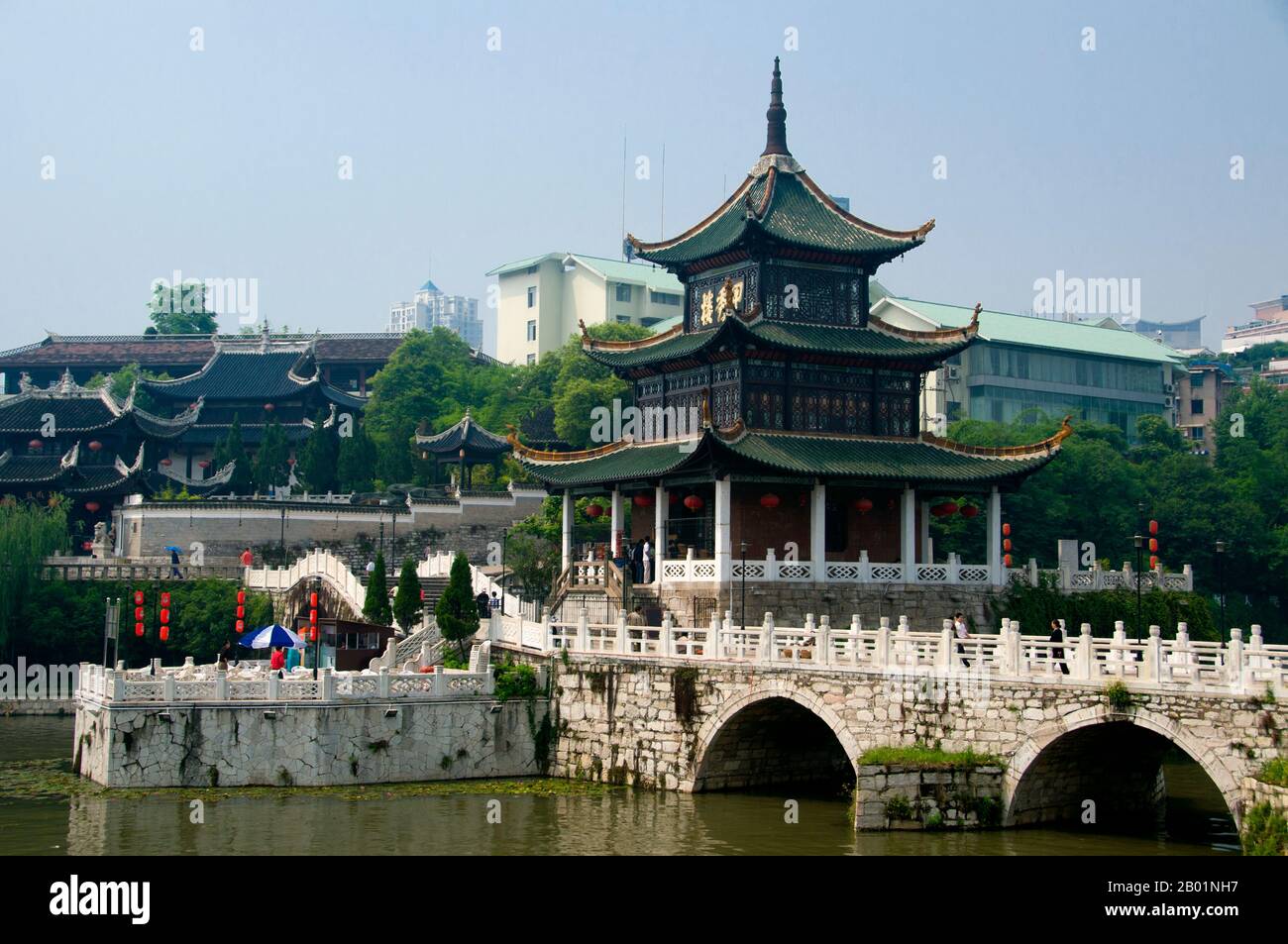 China: Jiaxiu Lou (erster Gelehrter-Turm) am Nanming River mit Cuiwei Yuan Teehaus im Hintergrund, Guiyang, Provinz Guizhou. Jiaxiu Lou (erster Gelehrter-Turm) wurde zusammen mit der Fuyu-Brücke ursprünglich 1598 (Ming-Ära) erbaut. Über die Brücke erreicht man den dreigeschossigen Turm. Der Turm wurde gebaut, um Studenten und Intellektuelle in ihrem Studium zu den Ming-Kaiserprüfungen zu ermutigen. Guiyang ist die Hauptstadt der chinesischen Provinz Guizhou und liegt östlich des Yunnan-Guizhou-Plateaus und am Nordufer des Nanming-Flusses, einem Zweig des Wu-Flusses. Stockfoto