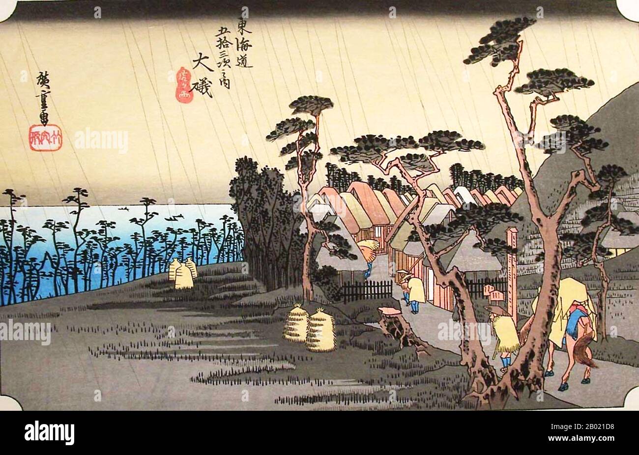 Japan: Station 8: Tigerregen am Bahnhof Ōiso. Ukiyo-e-Holzschnitt aus der Serie „Three Stations of the Tôkaidô Road“ von Utagawa Hiroshige (1797-1858), um 1834. Oiso: Der Weg durch Reisfelder entlang einer engen Straße, die von Bäumen gesäumt ist, zu einer kurvenreichen Straße mit Hütten, die das Meer überblicken, und Reisende, die das Dorf unter Regengüssen betreten. Diese Station war ein abgelegenes Küstendorf. Seit der Antike schrieben viele Dichter über dieses Meer in ihren Gedichten. Jetzt wurde eine Autobahn entlang der Küste gebaut und vorbeifahrende Autofahrer schenken diesem historischen Ort weniger Aufmerksamkeit. Stockfoto Japan: Station 8: Tigerregen am Bahnhof Ōiso. Ukiyo-e-Holzschnitt aus der Serie „Three Stations of the Tôkaidô Road“ von Utagawa Hiroshige (1797-1858), um 1834. Oiso: Der Weg durch Reisfelder entlang einer engen Straße, die von Bäumen gesäumt ist, zu einer kurvenreichen Straße mit Hütten, die das Meer überblicken, und Reisende, die das Dorf unter Regengüssen betreten. Diese Station war ein abgelegenes Küstendorf. Seit der Antike schrieben viele Dichter über dieses Meer in ihren Gedichten. Jetzt wurde eine Autobahn entlang der Küste gebaut und vorbeifahrende Autofahrer schenken diesem historischen Ort weniger Aufmerksamkeit. Stockfoto