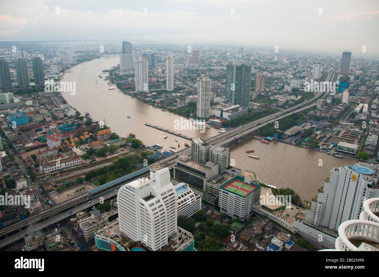 Obwohl Bangkok seit Hunderten von Jahren eine wichtige Stadt ist, saß es am Rande des Chao-Phraya-Flusses zwischen der antiken Hauptstadt Ayutthaya im Norden und dem Meer im Süden. Erst nach einer Reihe von Königreichen und Einfällen in den Regionen im Norden entwickelte sich Bangkok zu dem, was es heute ist. Die Geschichte Bangkoks beginnt im äußersten Norden Thailands. Der Boden, aus dem nun hohe Gebäude hervorsprießen, bot einst für Reis Sostenanz. Damals, noch vor 1.500 Jahren, lag das Gelände der zukünftigen Hauptstadt unter den Gewässern des Ozeans. Jede Monsunzeit, Stockfoto