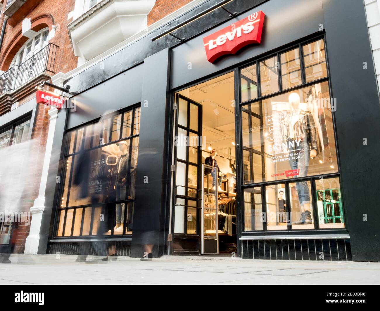 Levis Store, Covent Garden, London. Lange Belichtung, verschwommene Käufer,  die am Laden vor dem Modehaus der High Street, Levi's, spazieren gehen  Stockfotografie - Alamy