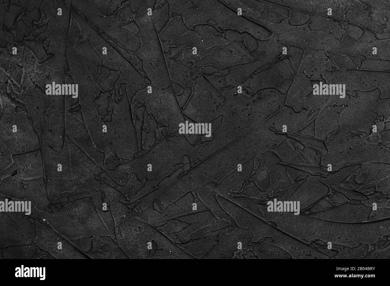Schwarze Betonwand mit Strukturierung für den Hintergrund. Kopierbereich. Nahaufnahme. Stockfoto