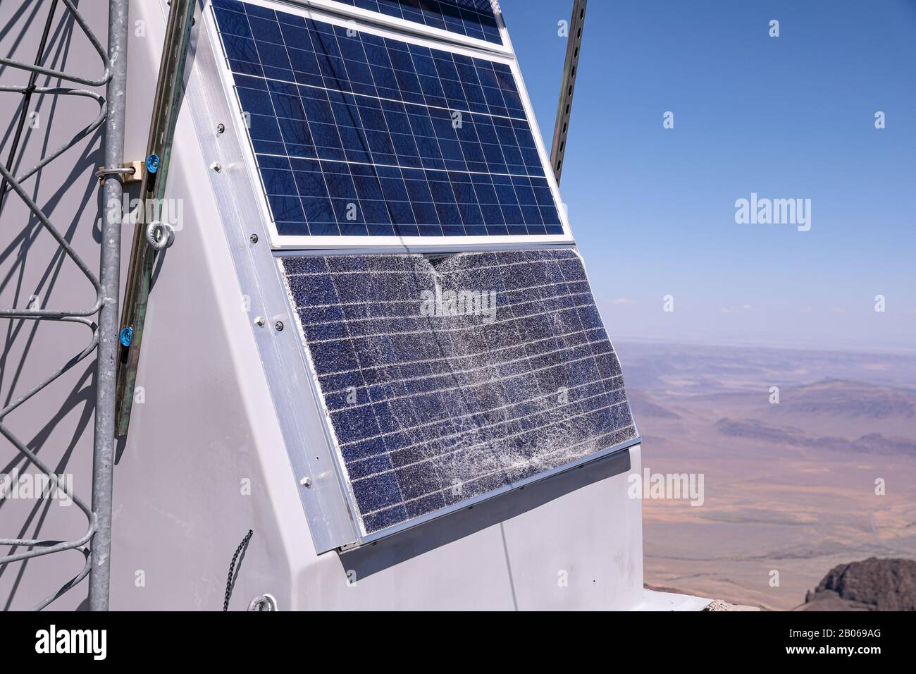 Kaputte oder vandalisierte Solarpaneele der elektrischen Stromversorgung für einen Mobilfunkturm an einem entfernten Standort. Stockfoto