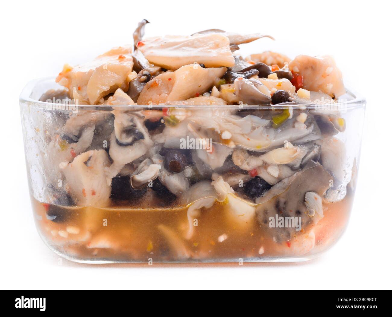 Eingelegte Austernpilze mit Gewürzen in einer Glasschale Stockfoto